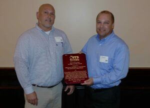 Mark Demidovich (L), presents Brook Martin of Cobb County DOT with the 2016 ITS Georgia Best of ITS Innovation Award
