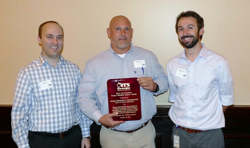 Mark Demidovich (C), presents the 2016 ITS Georgia Best of ITS Outstanding Public Member award to Alan Davis (L) and Matt Glasser of the Georgia Department of Transportation